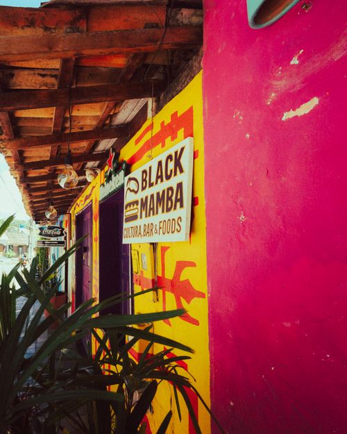 Free Colorful exterior of Black Mamba bar with bright mural and unique signage. Stock Photo