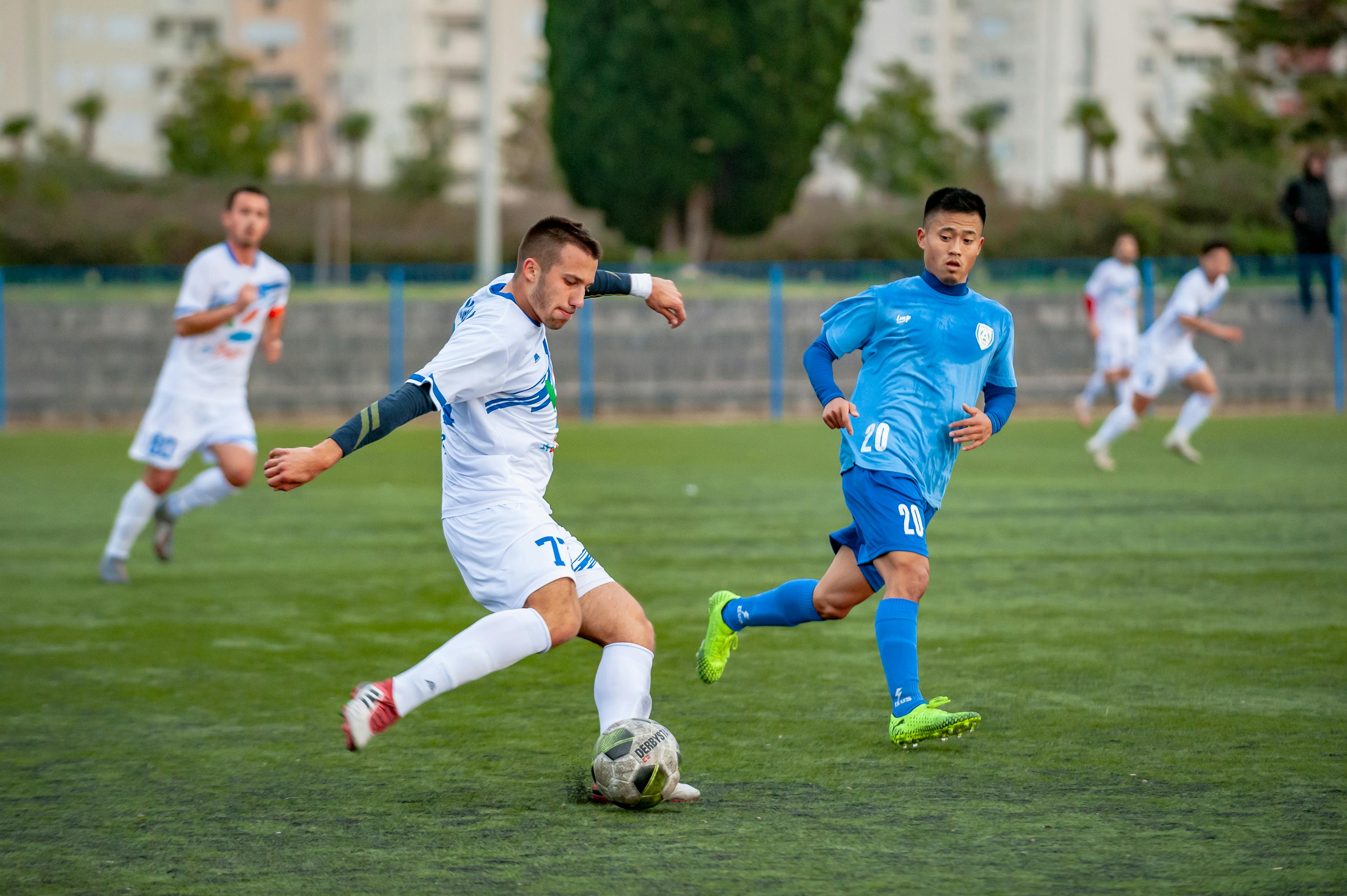 man wearing blue shirt looking on ball