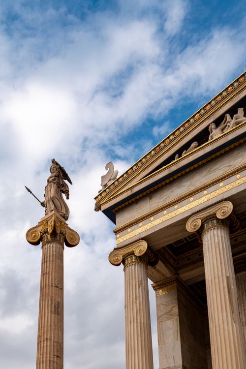 Free Stunning view of Athena statue and neoclassical columns under blue skies in Athens. Stock Photo
