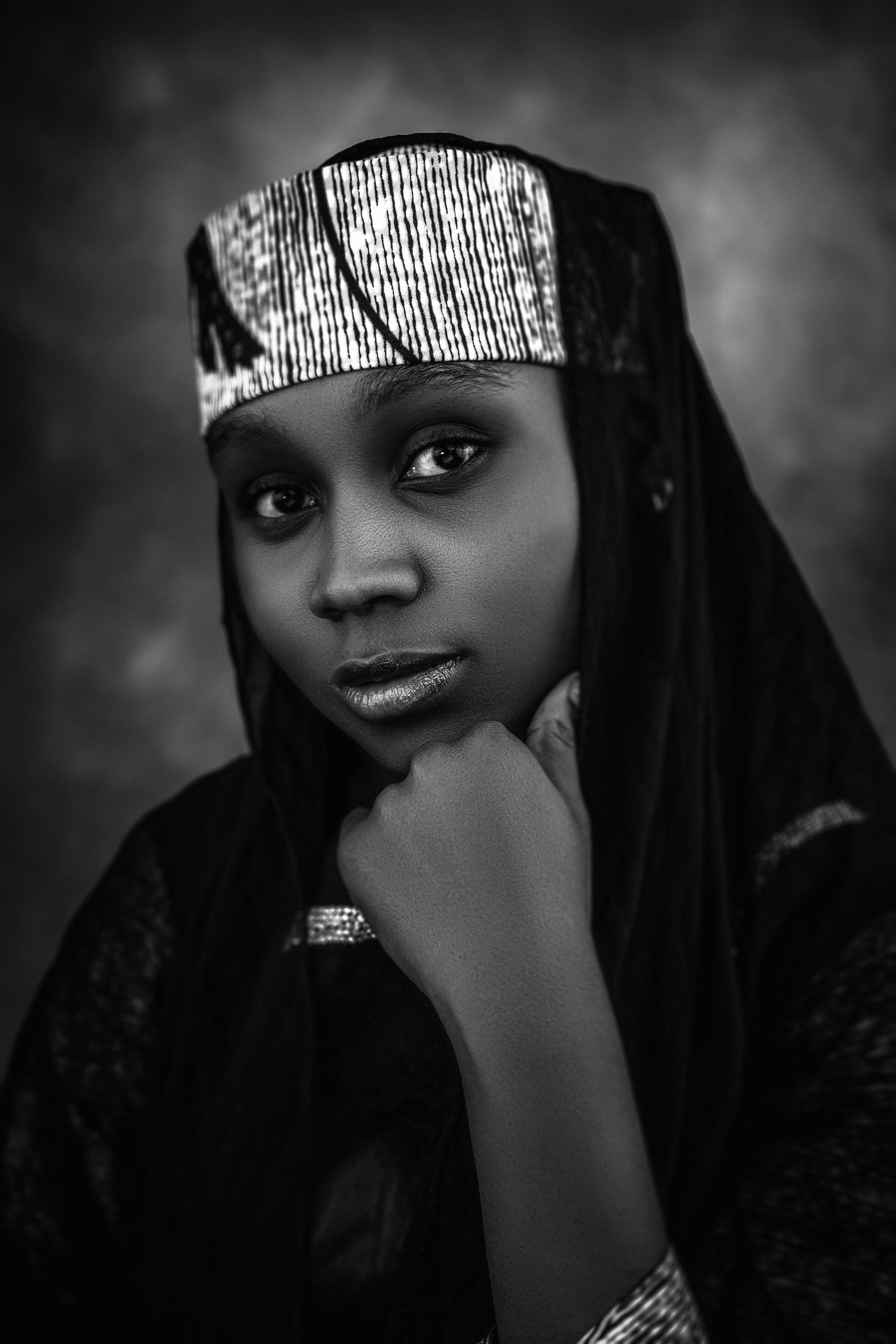 Black and white portrait of a woman wearing traditional clothing, exuding grace and elegance.