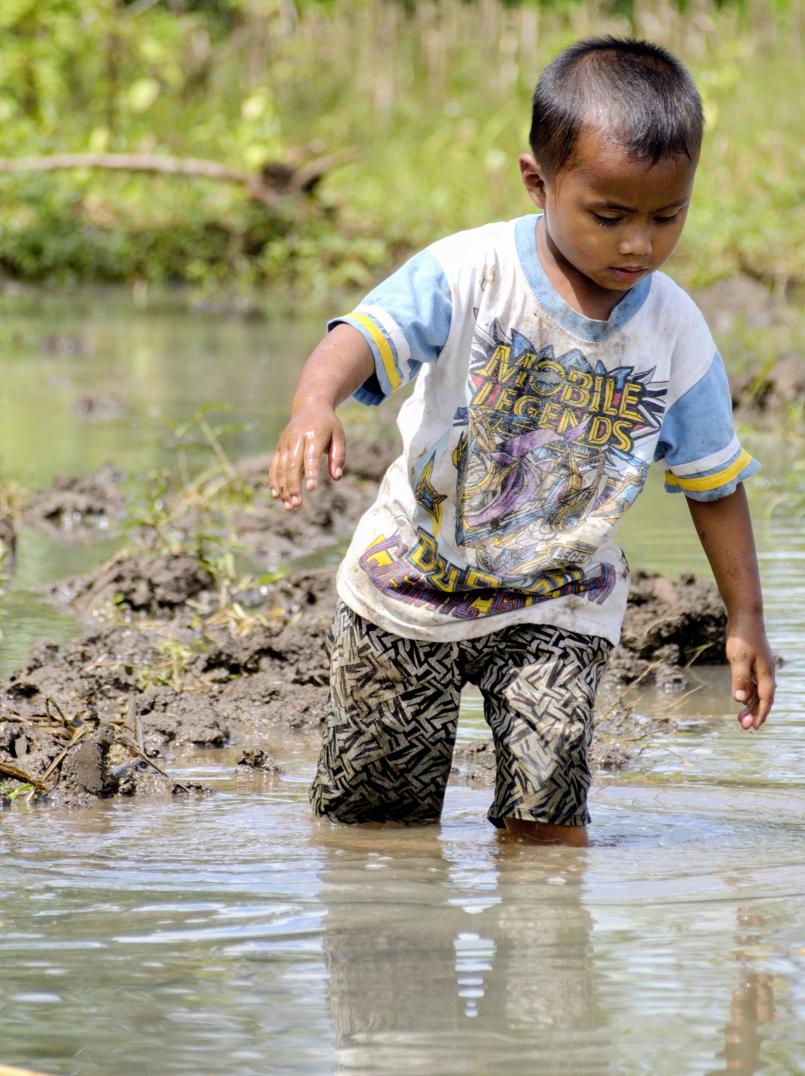 Young Child Playing in West Java Muddy Water
