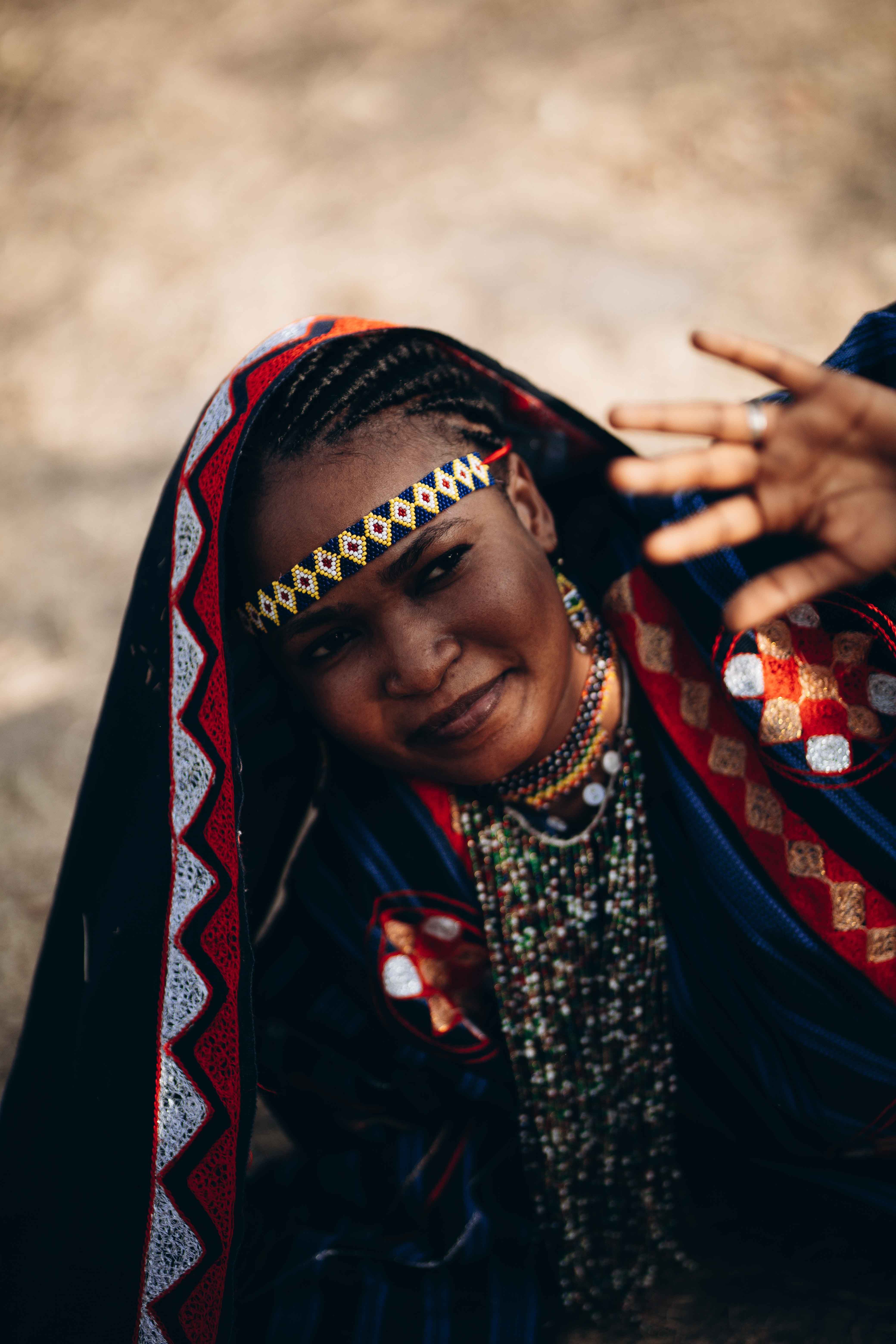Smiling woman in vibrant traditional attire, Namibia