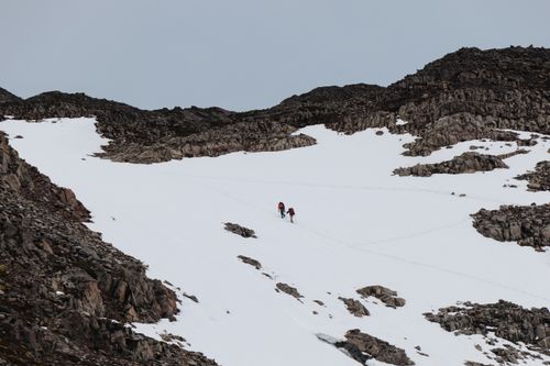 Free Two hikers ascending a snowy mountain slope in Patagonia, Chile, showcasing adventure and nature. Stock Photo