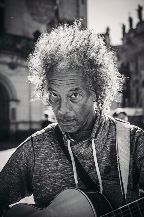 Free Black and white portrait of a street musician playing guitar in Dresden, Germany. Stock Photo