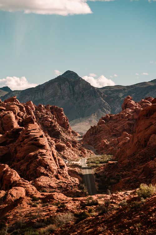 Free A picturesque view of the Red Rock Canyon in Moapa Valley with dramatic rock formations and a road leading through. Stock Photo