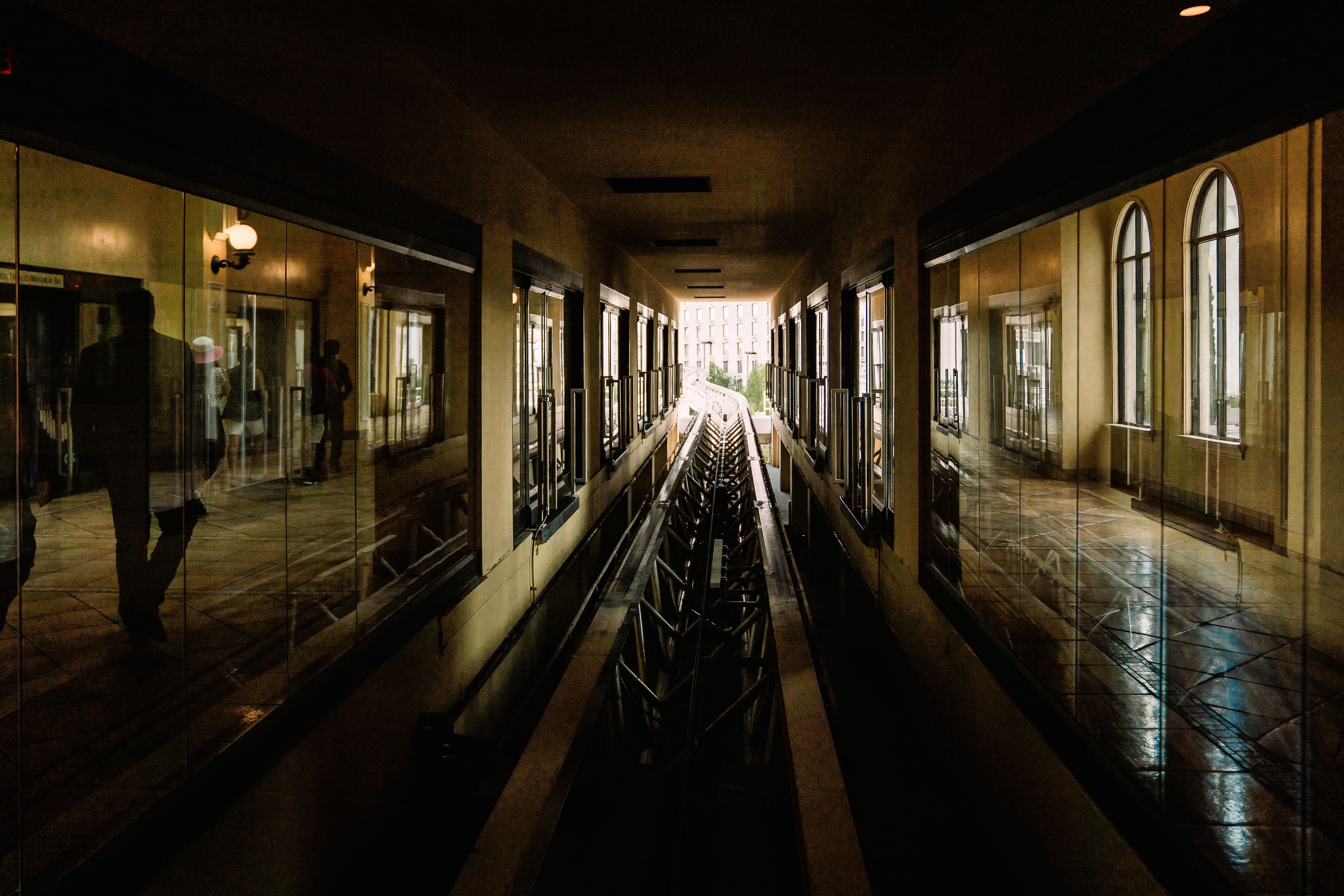 A moody reflection scene in a Las Vegas hotel corridor with arched windows and symmetry.
