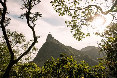 Free Scenic view of Christ the Redeemer statue framed by trees in Rio de Janeiro. Stock Photo