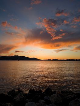 Stunning sunset over Fethiye Bay with vibrant clouds and serene sea, captured in Muğla, Türkiye.