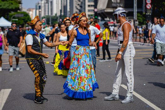 Colorful street performers in traditional attire celebrating dance culture in São Paulo, Brazil.