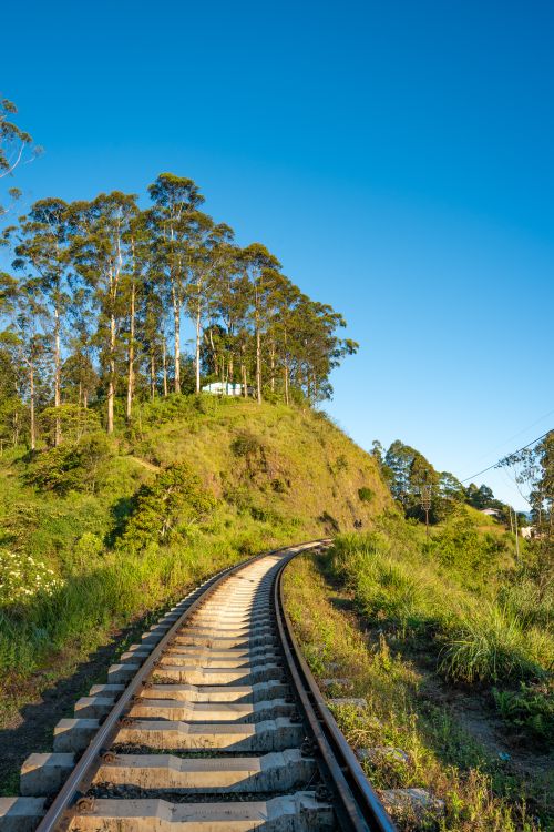 Free Explore the scenic railway track winding through lush green hills in Sri Lanka, capturing serene natural beauty. Stock Photo