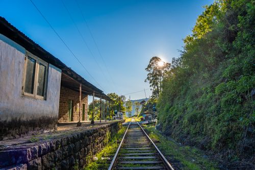 Free Picturesque railway track in Sri Lanka surrounded by lush greenery and rustic station. Stock Photo