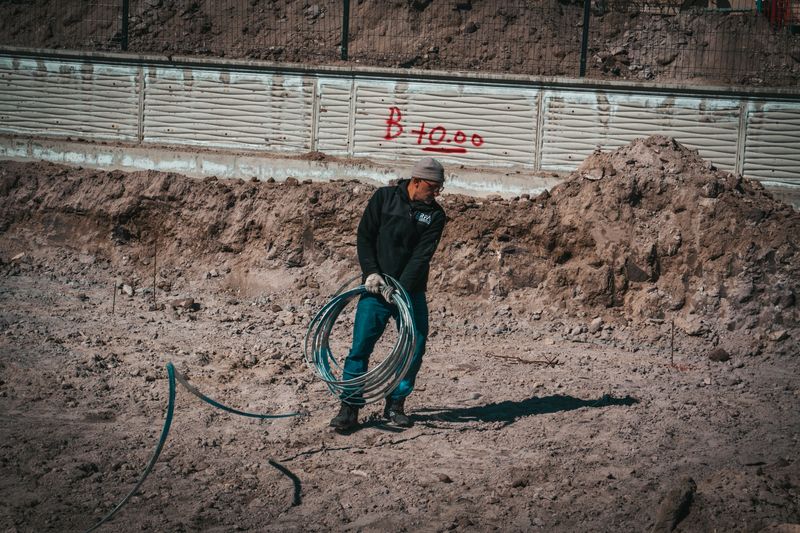 Worker handling insulated electrical cable