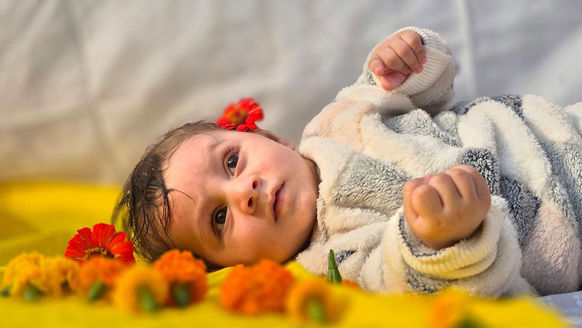 Baby among flowers