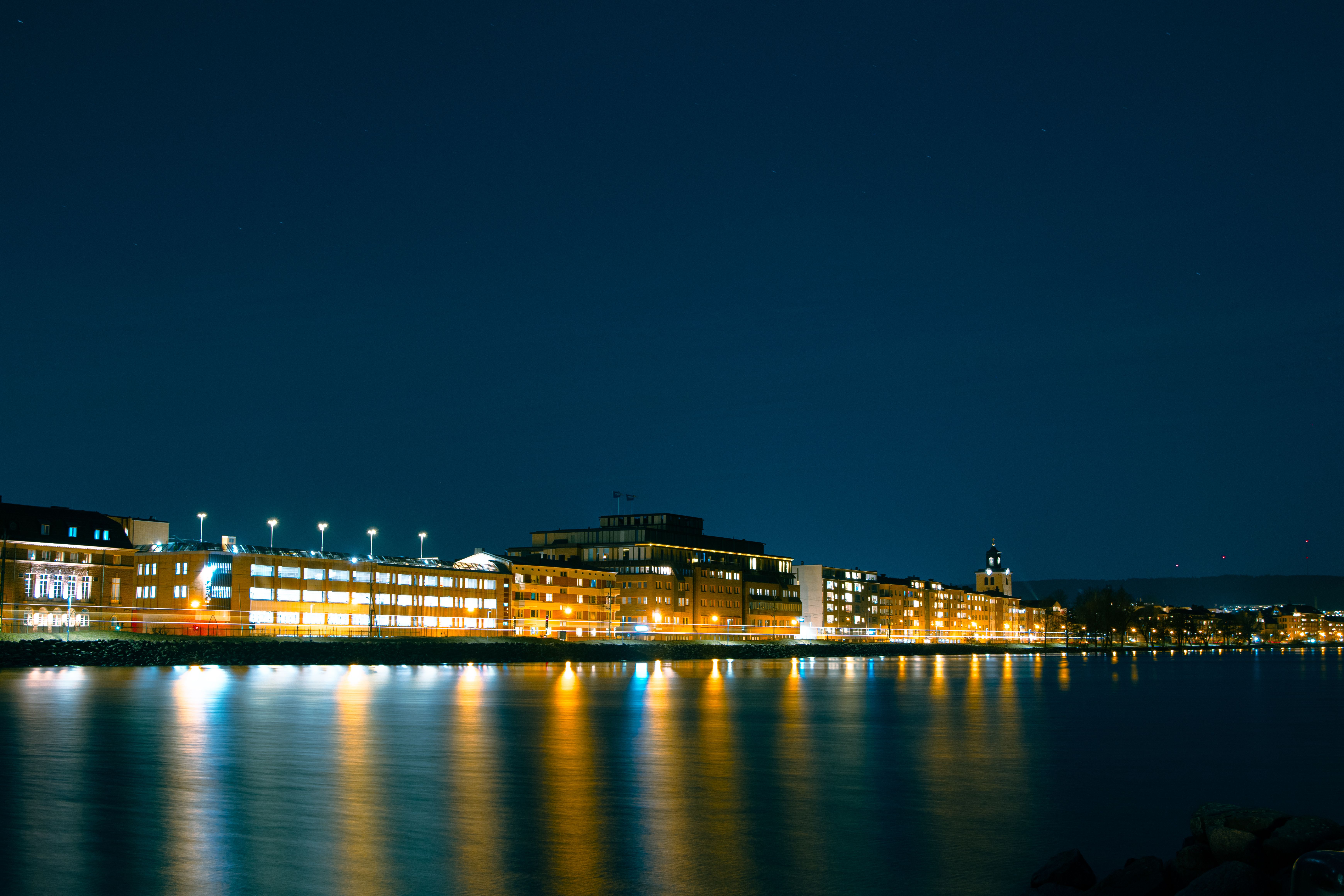 A City Skyline Near the Ocean at Night · Free Stock Photo