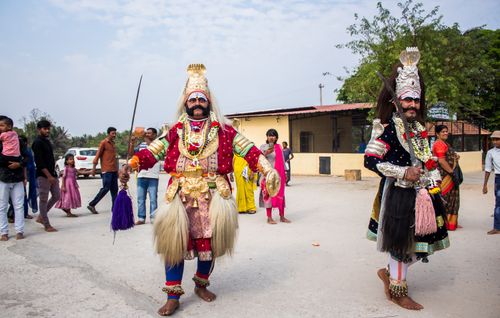 Free Vibrant Indian festival scene with performers in traditional costumes and attendees enjoying the event. Stock Photo