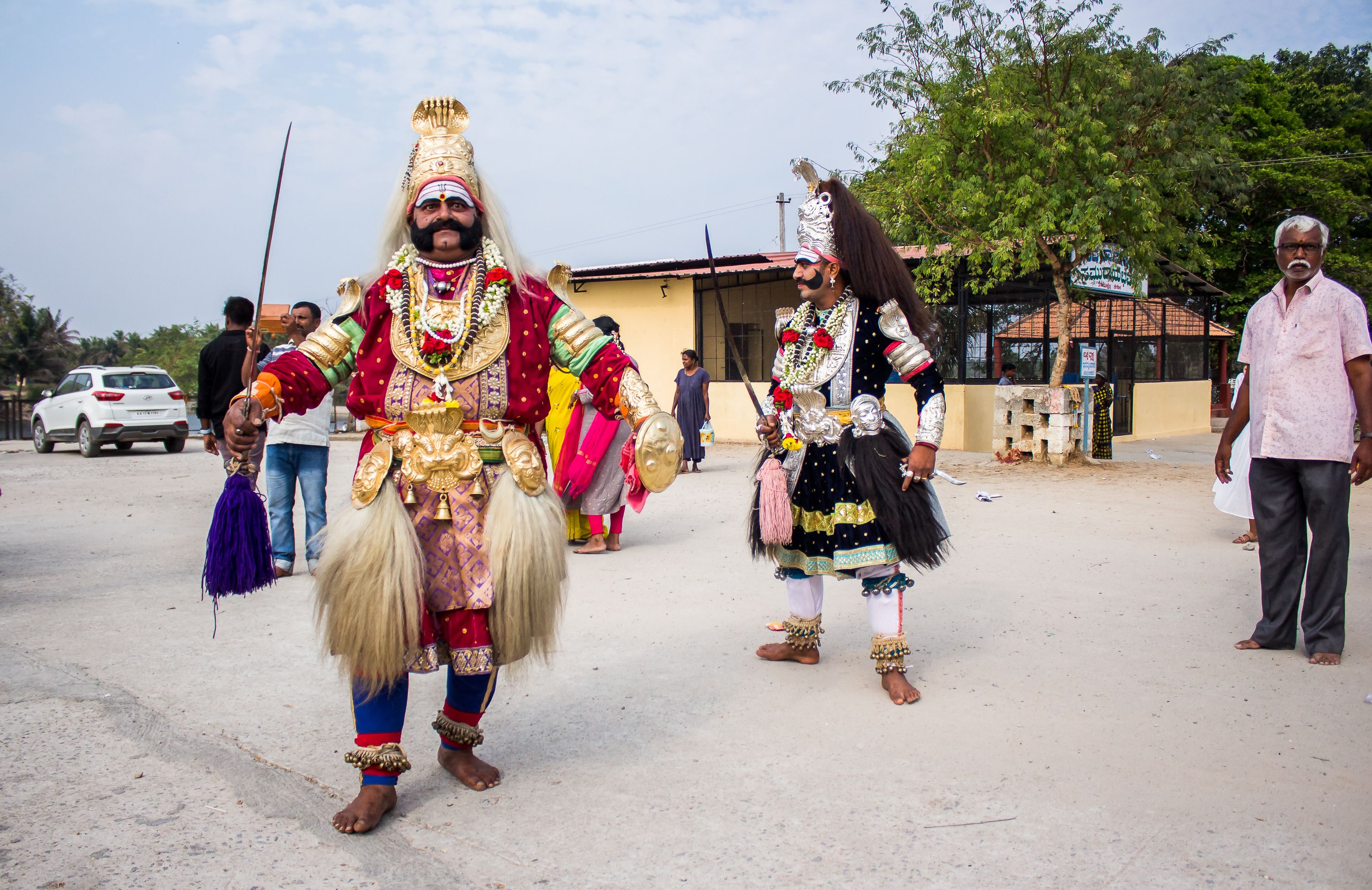 Vibrant traditional Indian street performers in colorful costumes with decorative accessories.