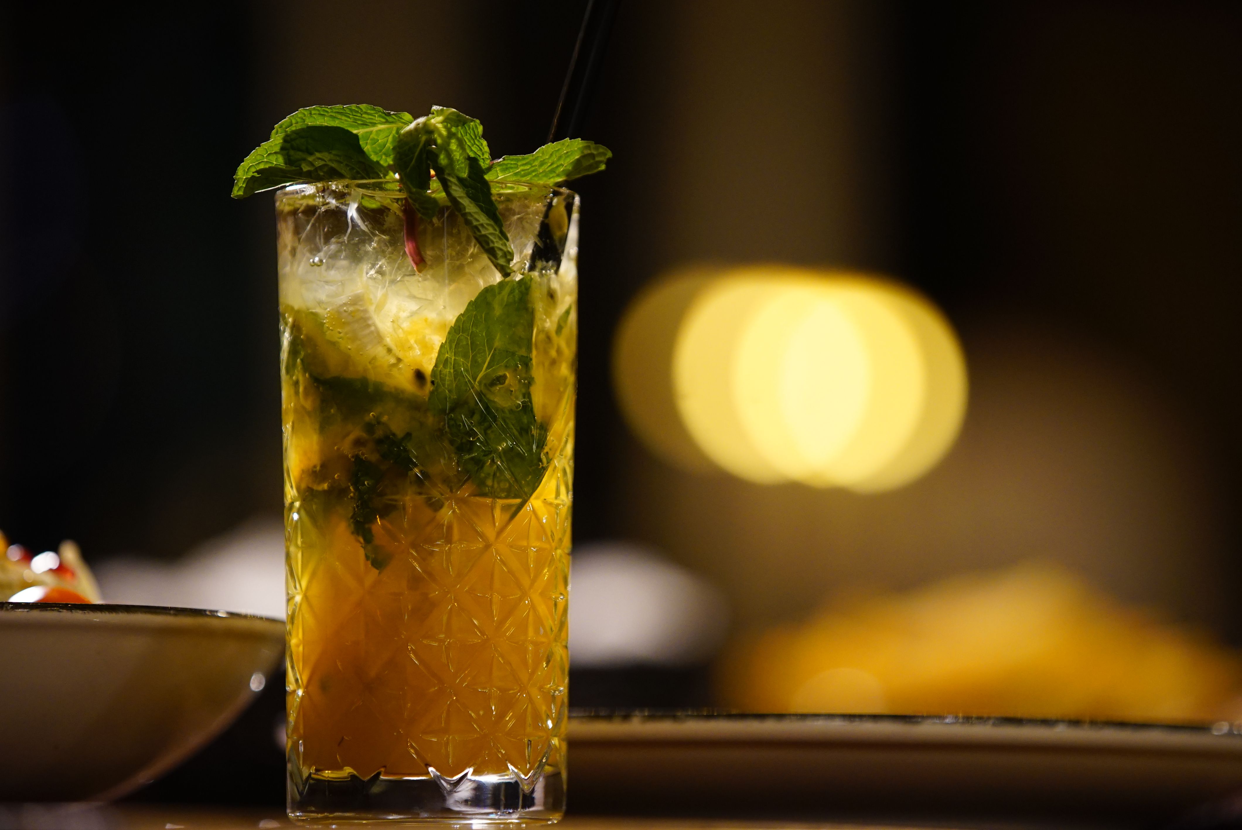 Sparkling lemonade served in a tall glass with lemon slices