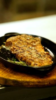 Mouthwatering grilled steak served on an iron skillet, perfect for savory and hearty meals.