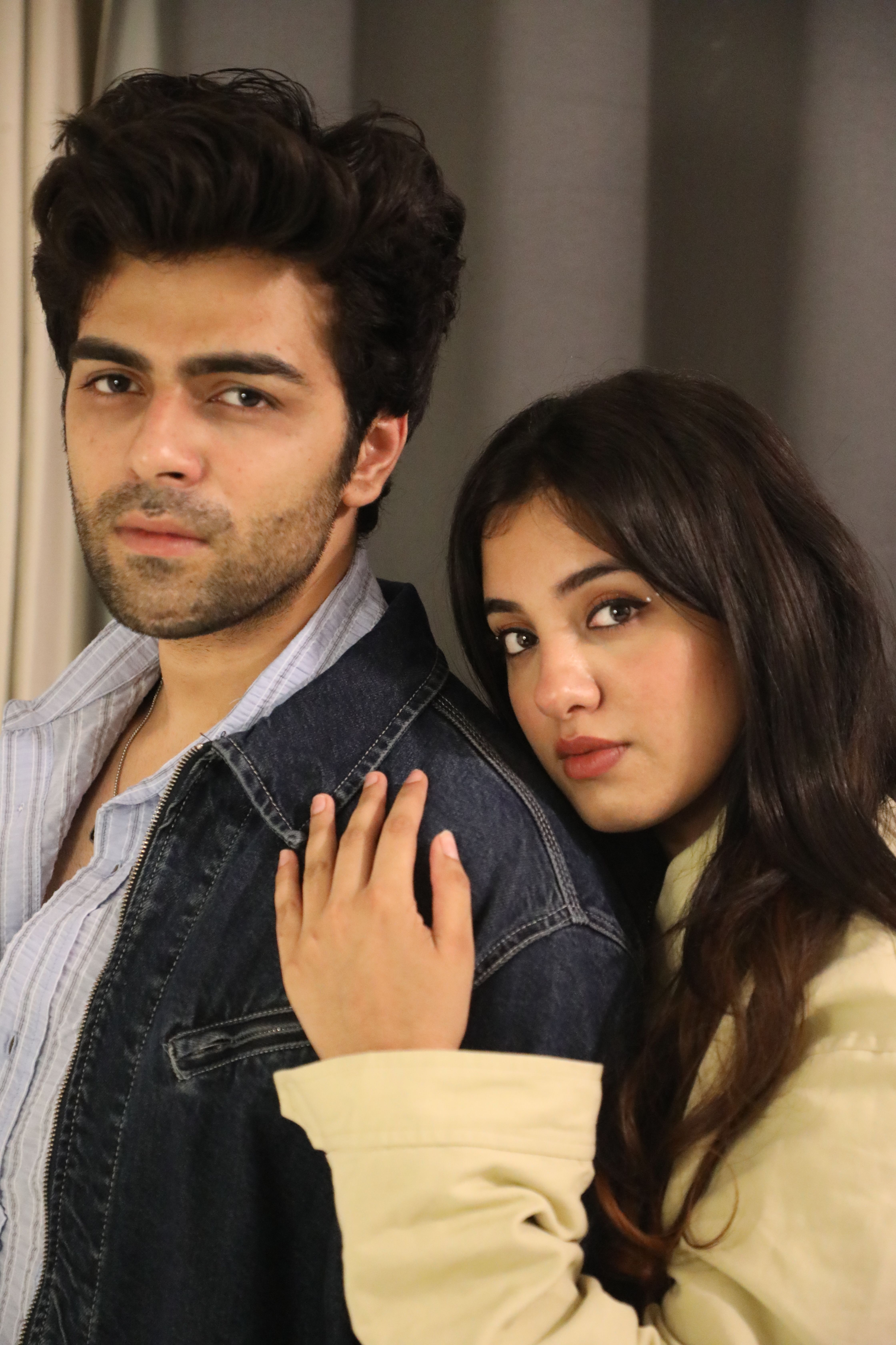 Close-up portrait of a young couple indoors, exuding warmth and intimacy.