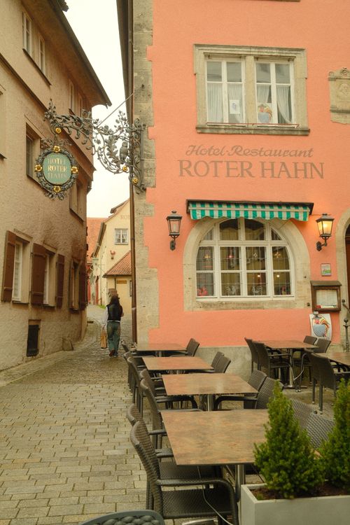 Free Picturesque street scene in Rothenburg ob der Tauber, featuring Hotel Restaurant Roter Hahn. Stock Photo
