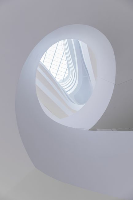 A stunning low-angle view of a modern spiral staircase with natural light in Melbourne.