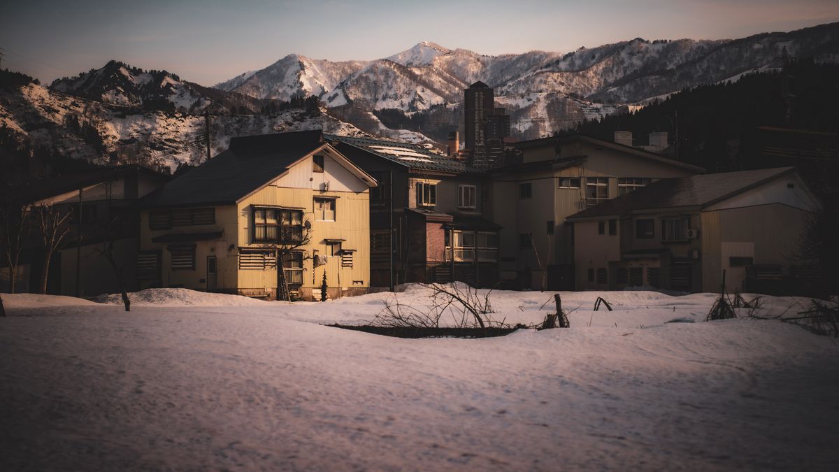 Snow-covered Japanese mountain village at winter twilight — the quiet landscape of inland Akita Prefecture