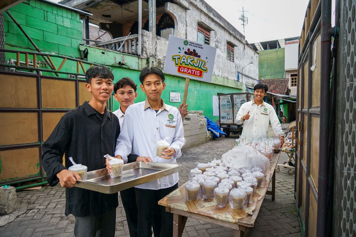 Young volunteers standing by prepared food packages