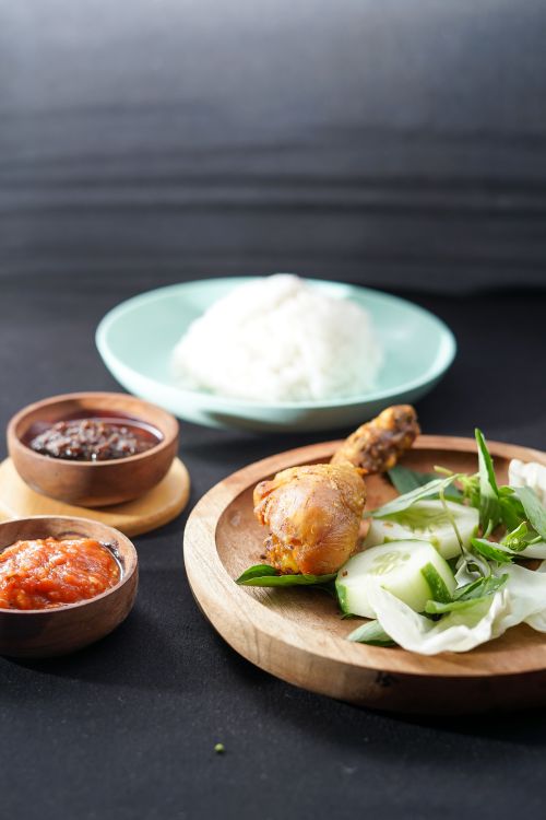 Free Indonesian cuisine featuring chicken, rice, and sambal sauce for a savory meal. Stock Photo