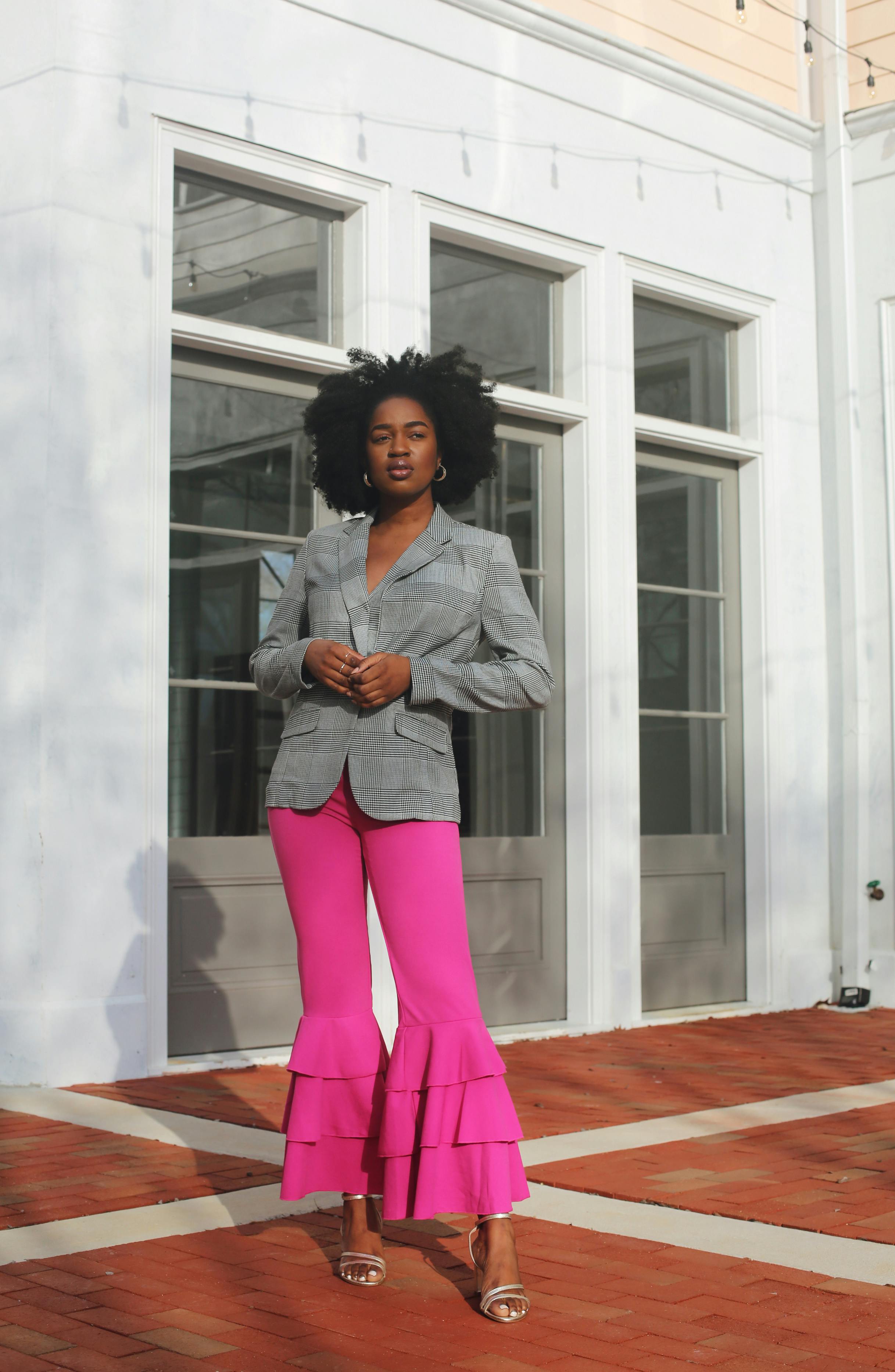A woman in a white shirt and pink pants photo – Black female Image on  Unsplash