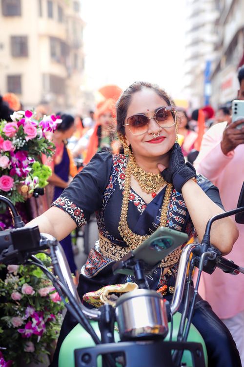 Confident Indian Woman on Motorcycle in Mumbai Parade · Free Stock Photo