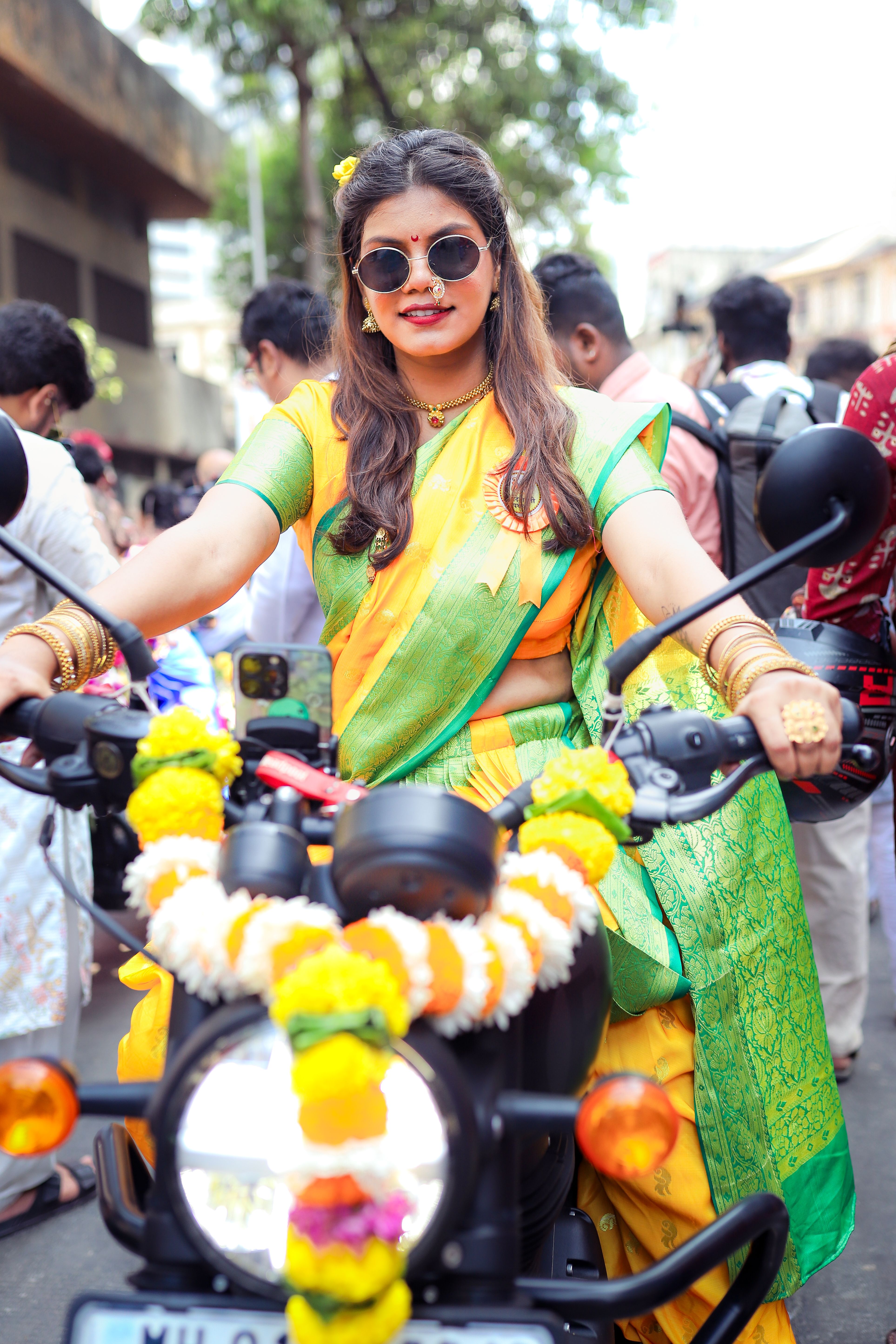 Woman in Traditional Saree Riding Decorated Motorcycle · Free Stock Photo