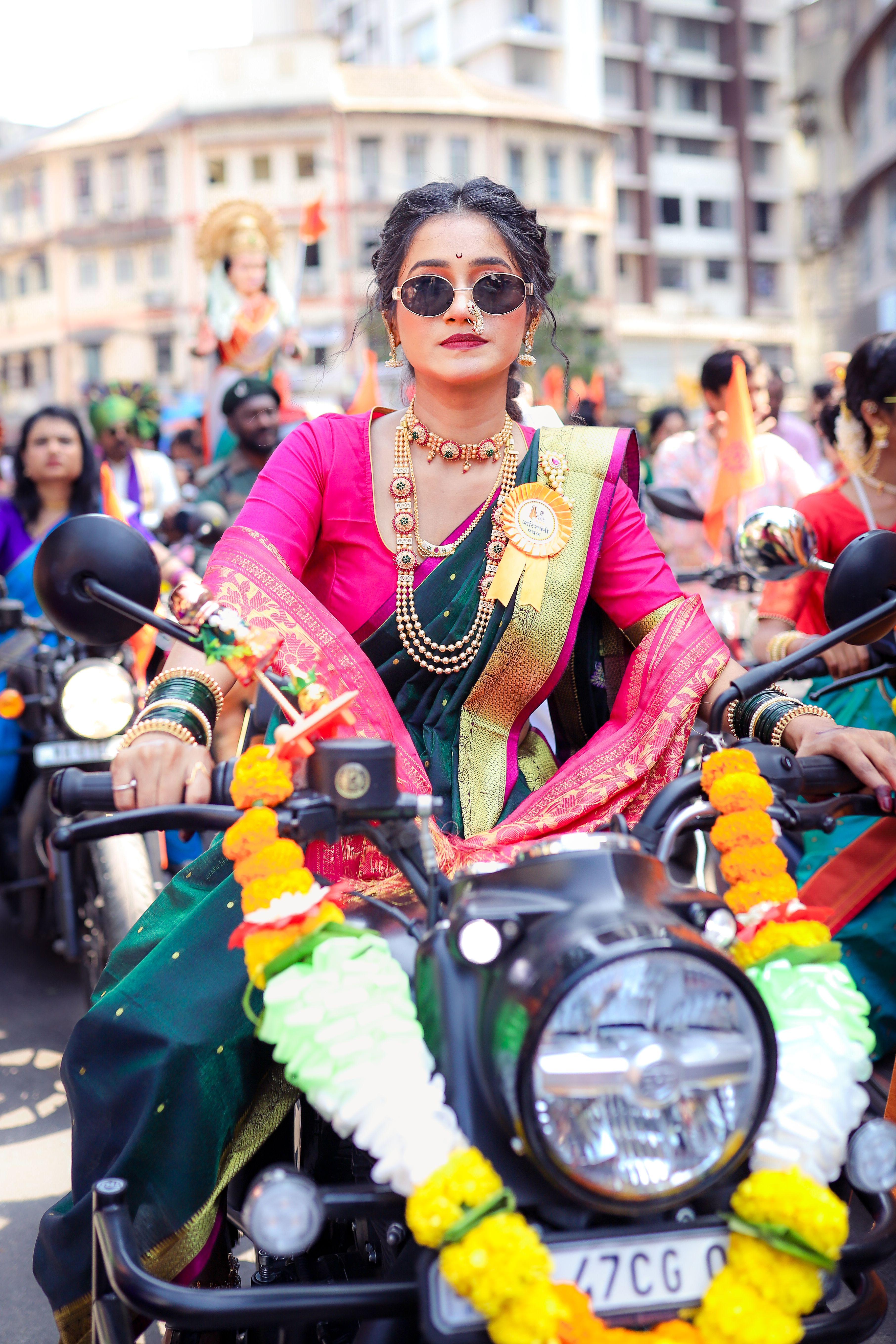Woman in Traditional Saree Riding a Decorated Motorcycle · Free Stock Photo
