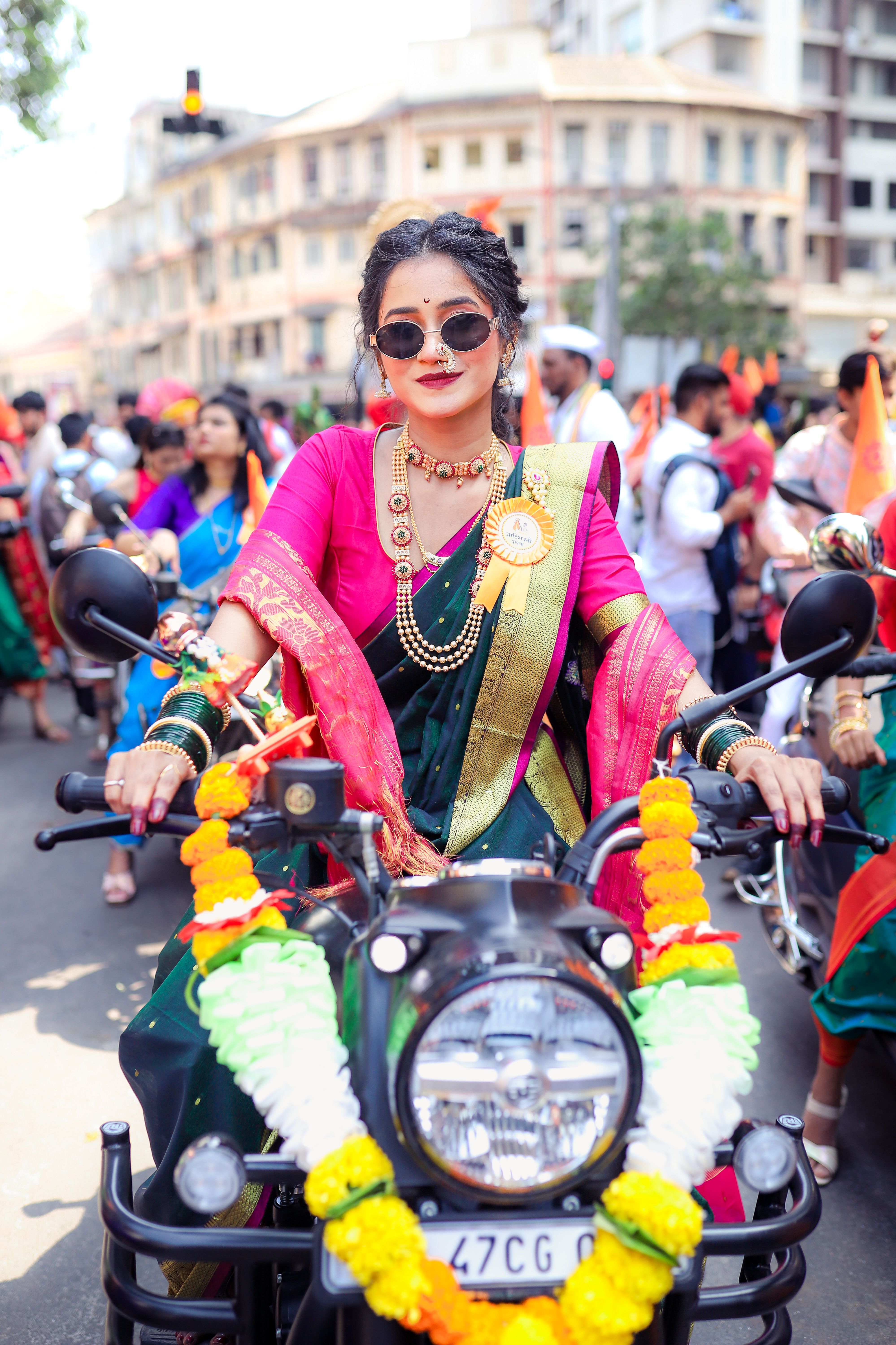 Woman in Traditional Attire Rides Decorated Motorcycle · Free Stock Photo