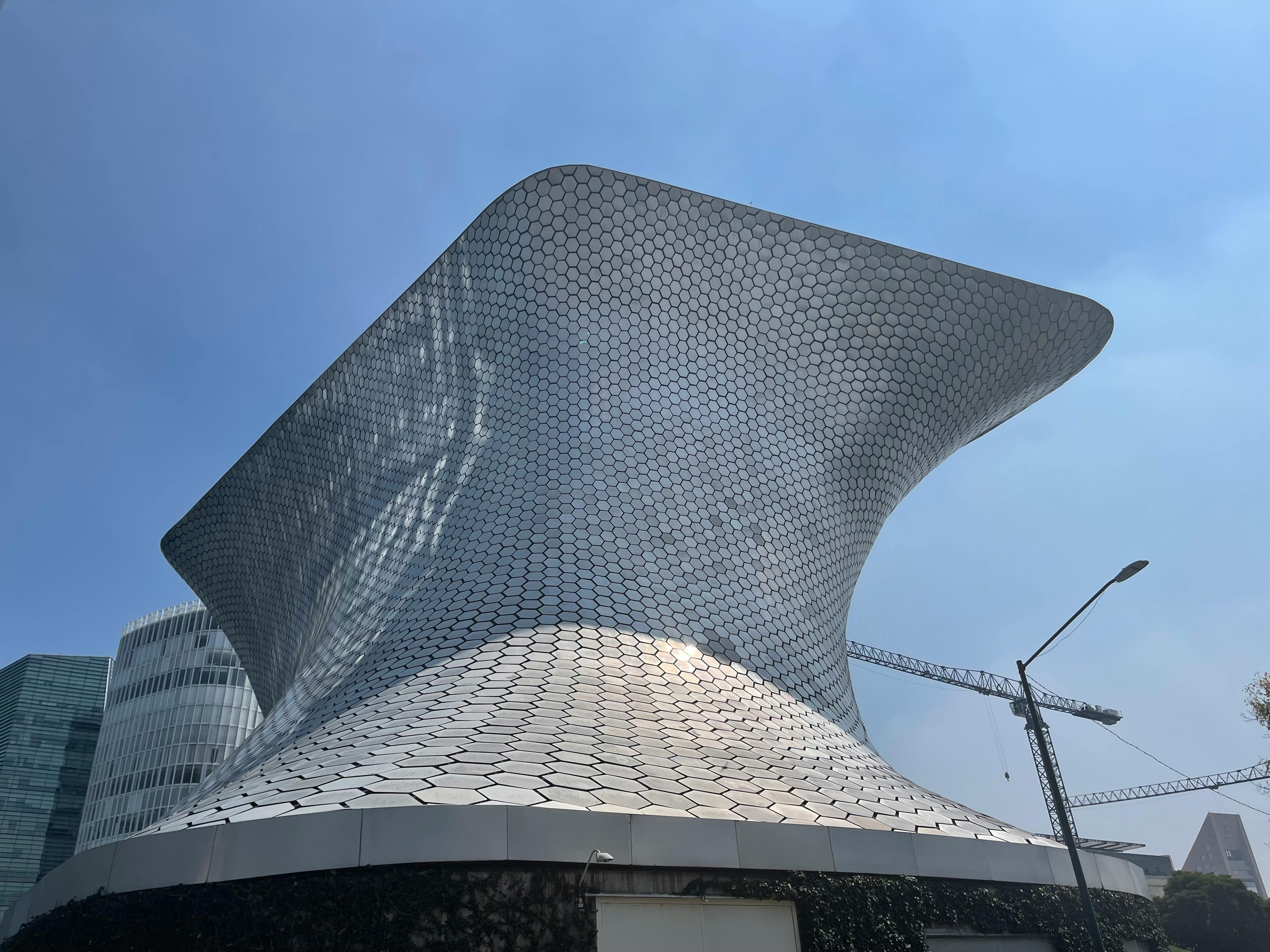 Striking architecture of Museo Soumaya with its hexagonal facade under a clear blue sky.
