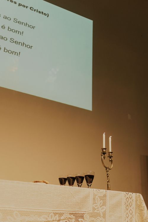 Free Church altar with communion elements including cups and candlesticks, ready for a religious ceremony. Stock Photo