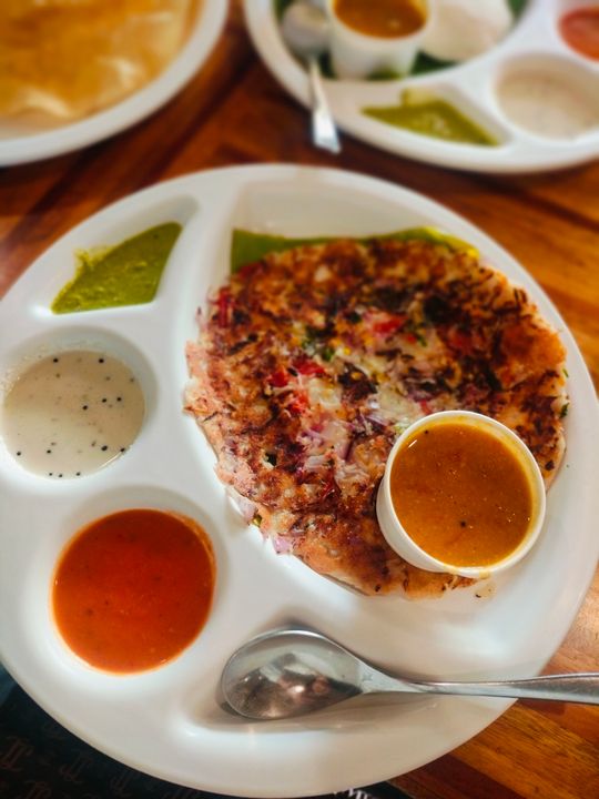Indian Regional Cuisines You Can Learn to Cook in Ahmedabad 1 South Indian rawa uttapam served with coconut chutney and dips — a classic dish from India's most distinctive regional cuisine.