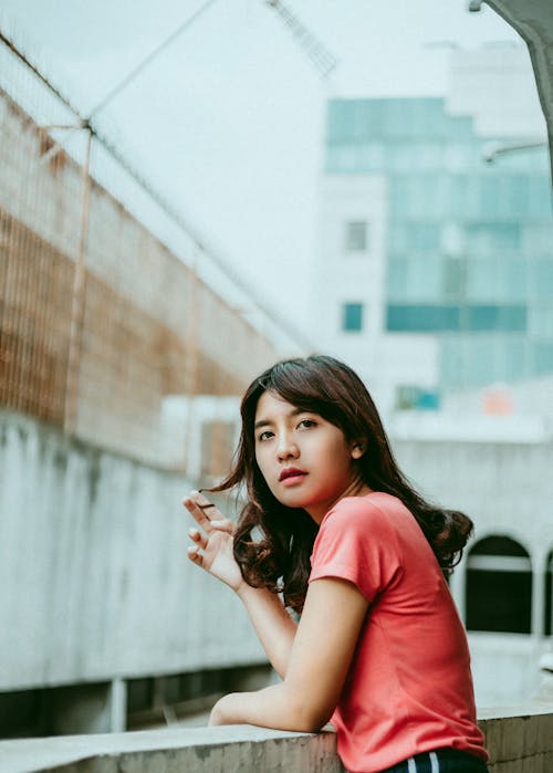 Woman on Pink Shirt Standing on Balcony