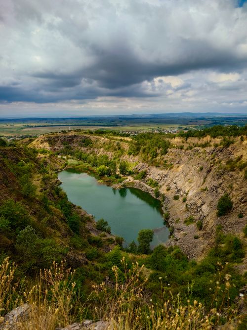 Free A breathtaking view of a quarry landscape in Tokaj, Hungary, showcasing lush greenery and a serene pond. Stock Photo