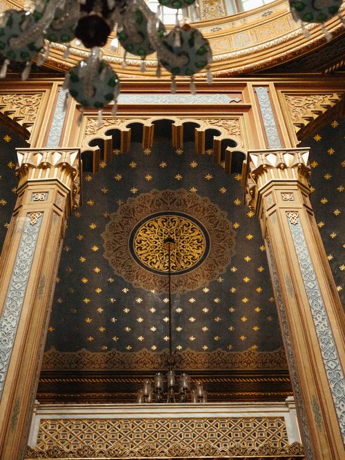 Free A detailed perspective of an ornate Islamic dome with gold accents and star patterns, highlighting intricate architecture. Stock Photo