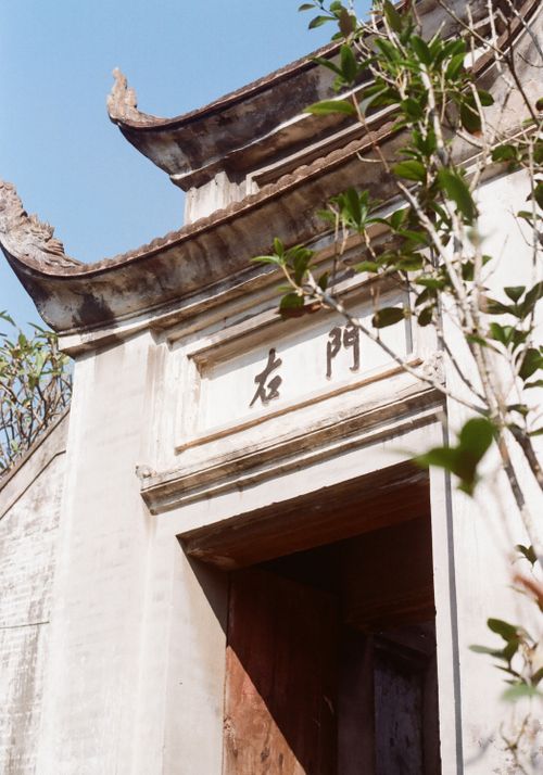 Free Historic temple gate with weathered stone architecture glowing in daylight. Stock Photo