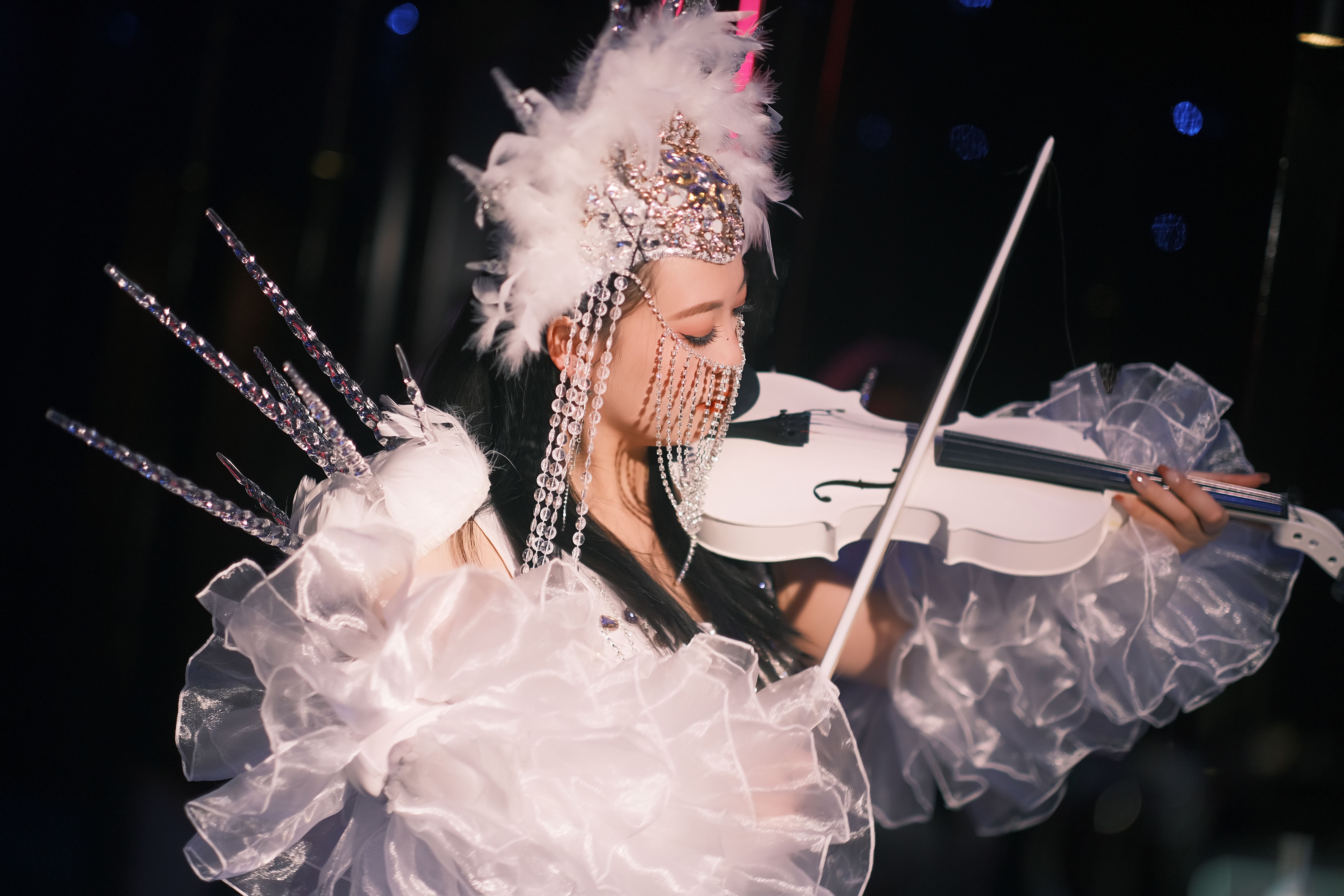 Extravagantly Dressed Performer Playing Violin on Stage · Free Stock Photo