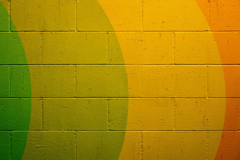 Vibrant abstract design on a textured brick wall, ideal for backgrounds.