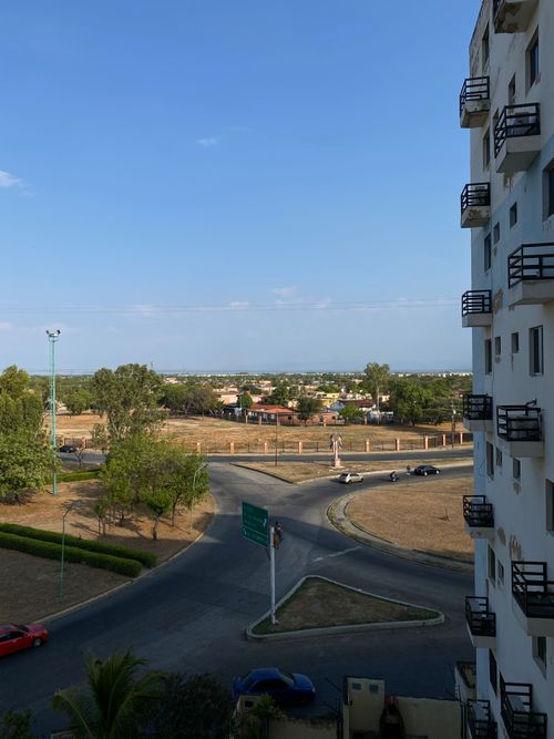 Free View of a cityscape from a high-rise in Venezuela, capturing roads, buildings, and green spaces. Stock Photo