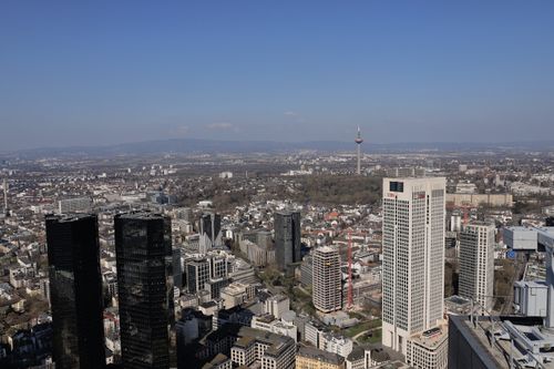 Free Aerial view of the Frankfurt skyline featuring tall skyscrapers against a clear blue sky. Stock Photo