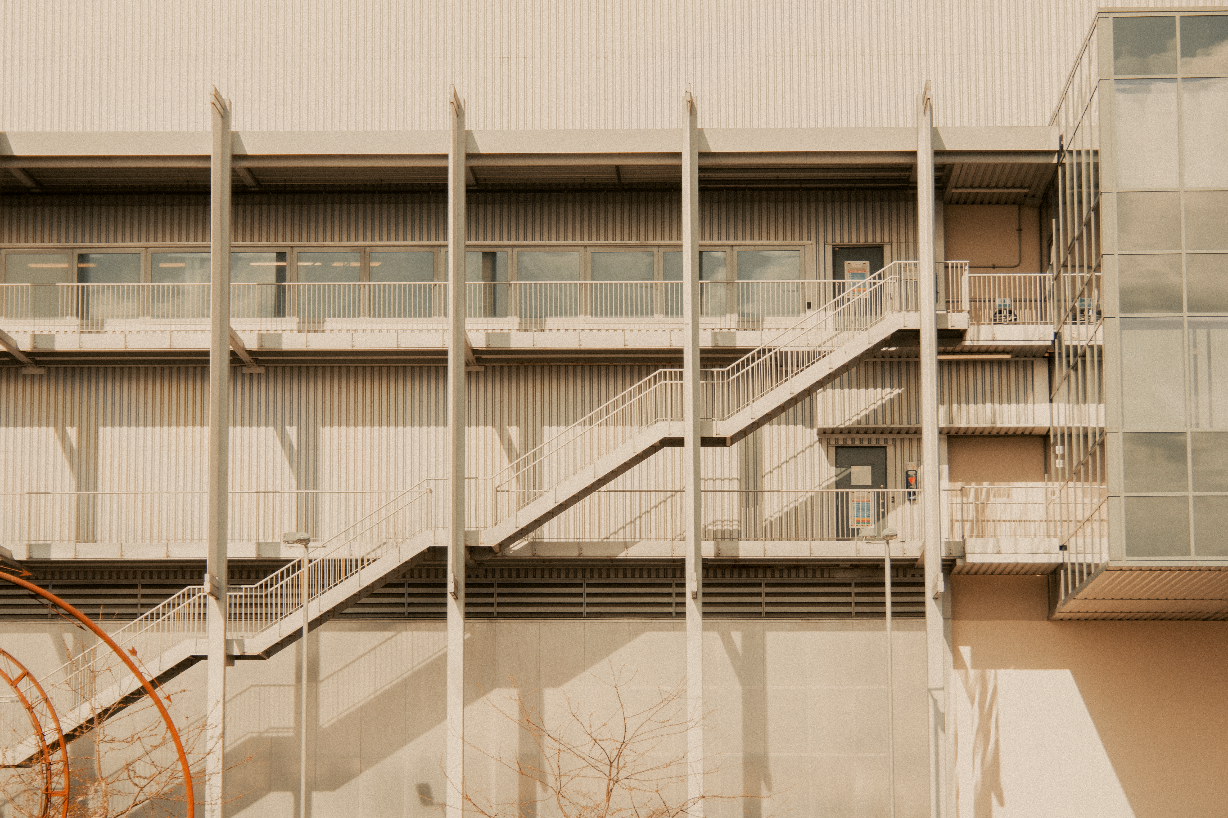 A modern industrial building facade with exterior metal stairs in Shrewsbury, England.