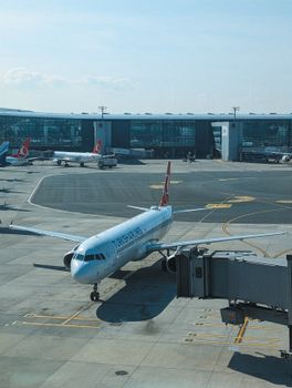 A bustling view of airplanes at İstanbul Airport, showcasing modern aviation and travel.