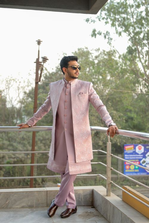 Free Elegant man in traditional Indian attire posing outdoors in a serene setting. Stock Photo
