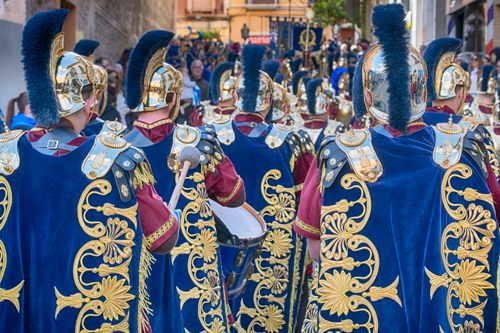 Free Roman soldiers in ornate armor parade through a bustling street. Stock Photo