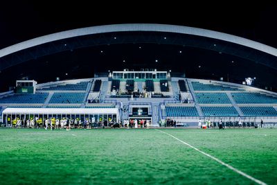 Empty north stand seen from the pitch at night — photo by Jeffrey Paa Kwesi Opare on Pexels
