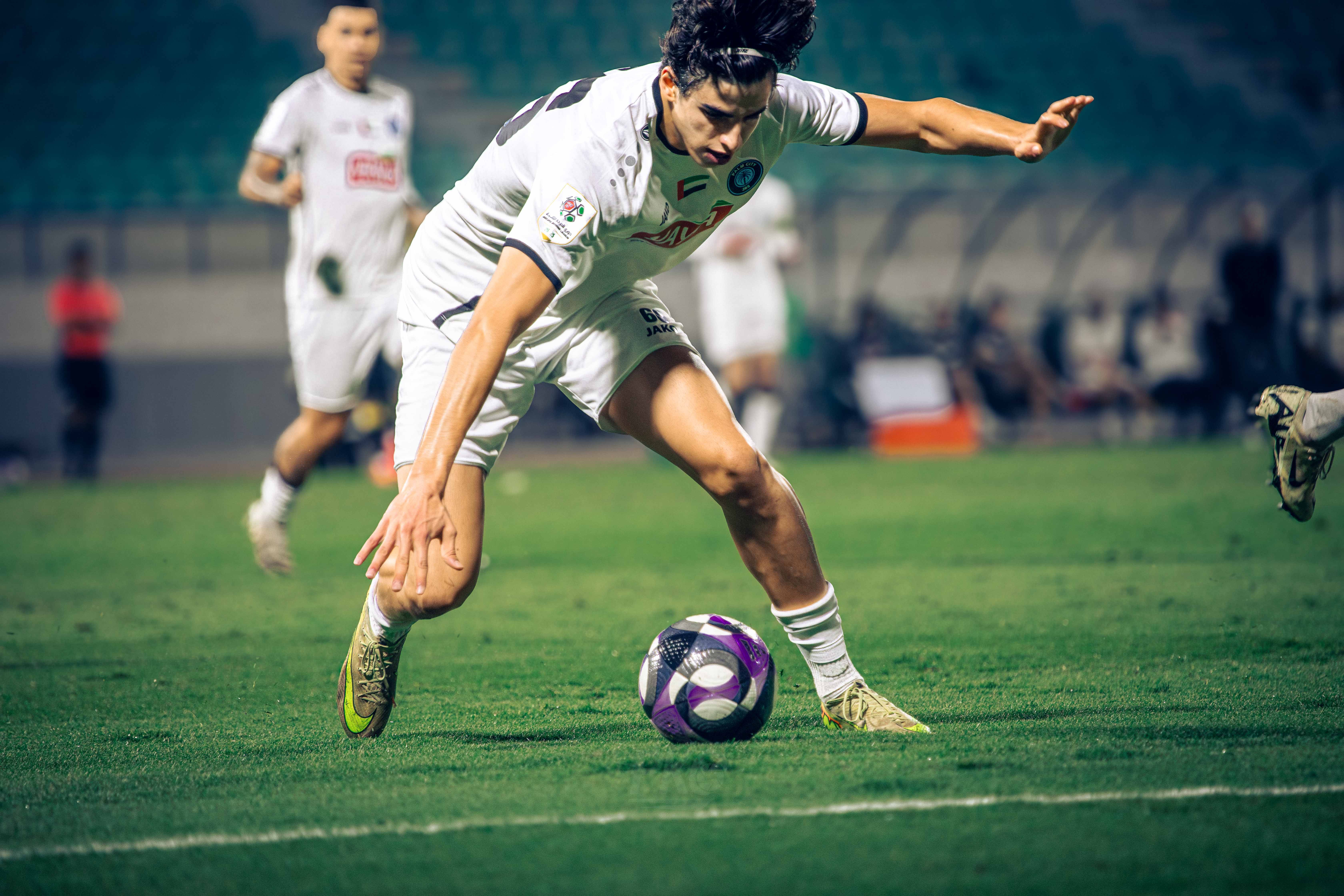 Energetic soccer player in intense match, demonstrating skill and agility.